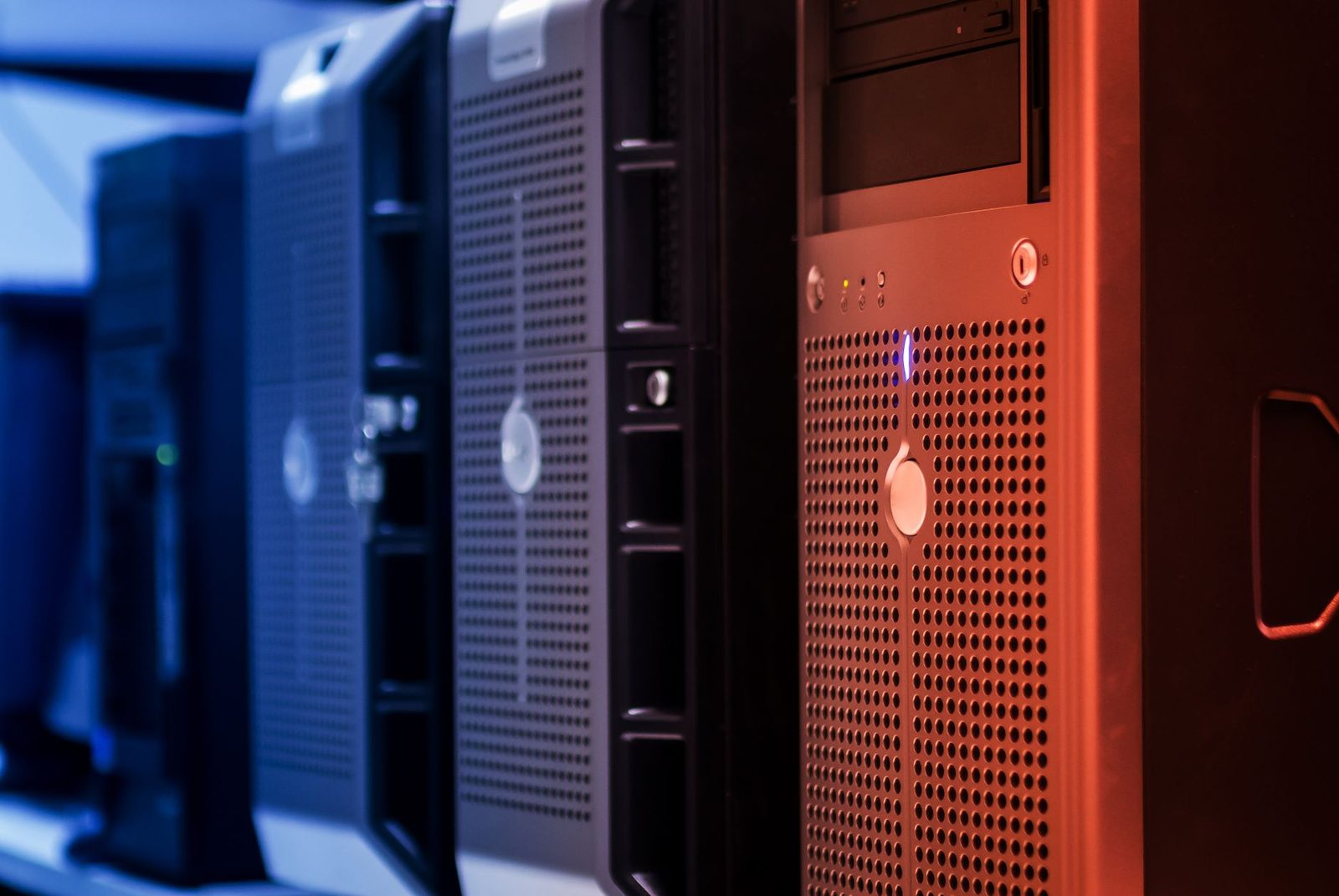 Rangée de serveurs informatiques dans un centre de données, éclairés en bleu et rouge